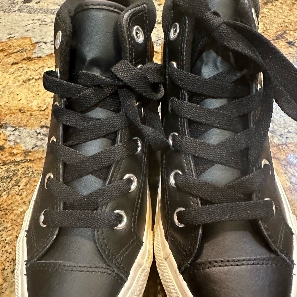 Converse black leather high top sneakers. Boys size 5 fits women’s size 7.